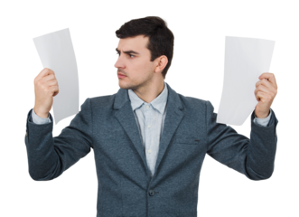 Surprised young accountant holding two papers in his hands, looking shocked aside isolated on transparent background