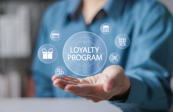 Loyalty program concept, Customer Engagement. Businessman holding loyalty program icon on virtual screen.