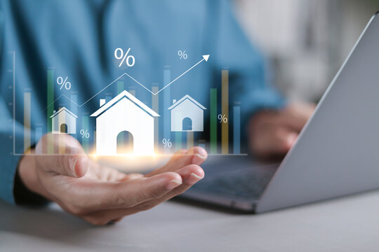 Real estate investment concept. Interest rate, Investment planning, business real estate. Person holding House icon for analyzing mortgage loan home and insurance real property mortgage.