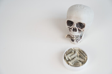 Skull Chewing Tobacco on a White Table.