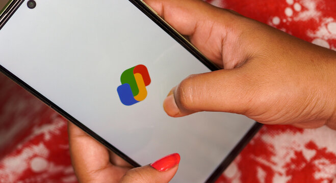 West Bengal, India - May 16, 2025: Gpay a money transferring app by google for India through UPI. Woman using Google payment system UPI.