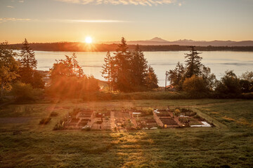 Aerial view of a Community garden located on an island in the Pacific Northwest. Beautiful morning light illuminates a garden area set aside on a land preserve in the Salish Sea area of Washington.
