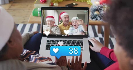 Grandmother and daughter using laptop technology joining virtual holiday call with floating hearts - Powered by Adobe