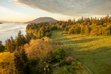 Aerial view of the east side of Lummi Island during a beautiful sunrise over the Curry Preserve.  Located in the Salish Sea with Lummi Mountain in the background and Hale Pass to the east.