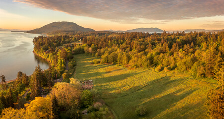 Aerial view of the east side of Lummi Island during a beautiful sunrise over the Curry Preserve.  Located in the Salish Sea with Lummi Mountain in the background and Hale Pass to the east.