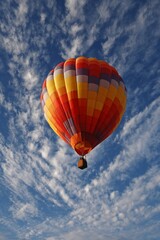 Fototapeta premium Hot air balloon soars in summer sky. Travel, adventure, escape, recreation