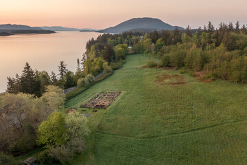 Aerial view of the east side of Lummi Island during a beautiful sunrise over the Curry Preserve.  Located in the Salish Sea with Lummi Mountain in the background and Hale Pass to the east.