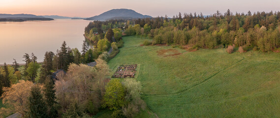 Aerial view of the east side of Lummi Island during a beautiful sunrise over the Curry Preserve.  Located in the Salish Sea with Lummi Mountain in the background and Hale Pass to the east.