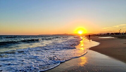 Sunset beach scene waves lap sandy shore with a distant figure, golden light reflecting in the water