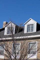 Dormer windows, attic of the house. Residential building
