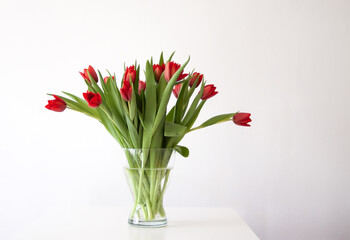 Red tulips. Beautiful spring flowers. Romantic bouquet in minimalist style interior.