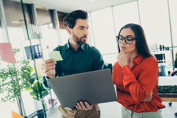 Professional colleagues collaborating on a project in a modern office workspace, sharing ideas and strategizing for business solutions