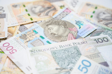 Polish paper money, creating a vibrant texture of national currency. Perfect for illustrating Polish economy, savings, business finance, investment in local currency and fiscal strategies.