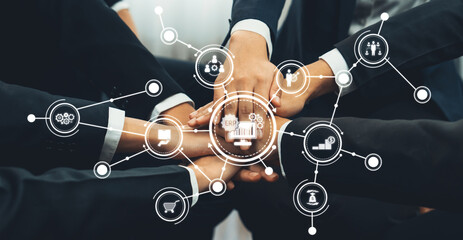 This image depicts a diverse group of professionals engaging in teamwork, surrounded by digital icons representing various business concepts, showcasing collaboration and innovation. Amity