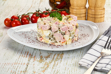 Russian traditional Olivier salad with sausages