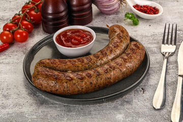 Grilled beef sausages with sauce