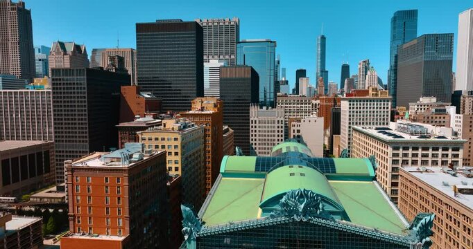 Approaching the roof of Harold Washington Library Center. Drone flight over the tops of the buildings in Chicago, Illinois, USA.