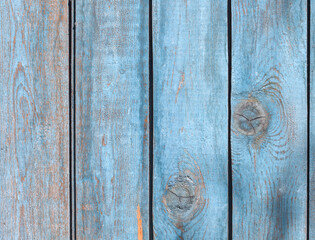 A fence made of pine boards. Old, worn, cracked board. Texture, background.