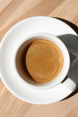 Coffee. Fresh Espresso in White Cup on Wooden Background. 
