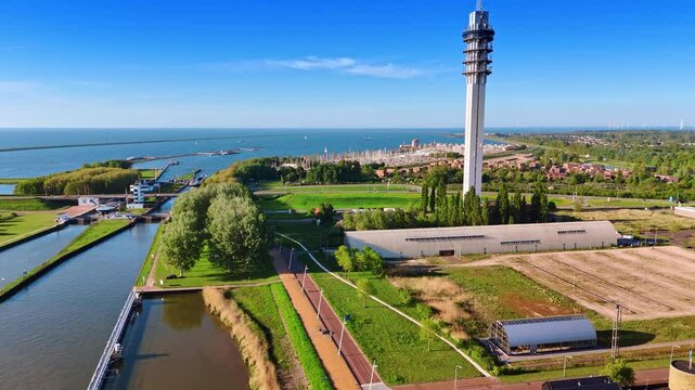 Lovely green waterfront of Lelystad, the Netherlands. Aerial perspective on telecom tower and yacht club at backdrop.