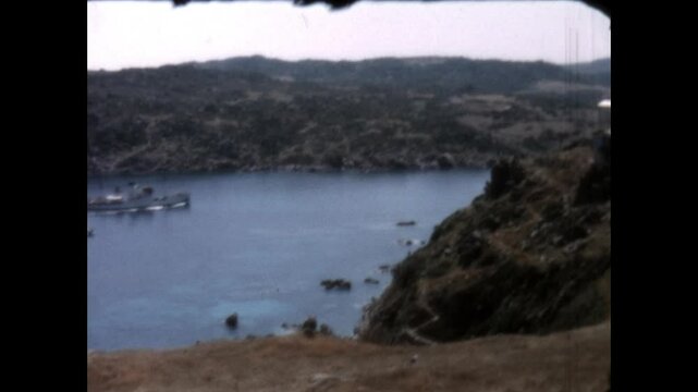 View from Longonsardo Tower 1964 - Views from Longonsardo Tower, in Santa Teresa Gallura on the island of Sardinia, include arriving boats, Rena Bianca Beach, and the tower itself, in 1964.