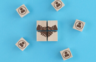 A wooden block with a hand on it is surrounded by other wooden blocks