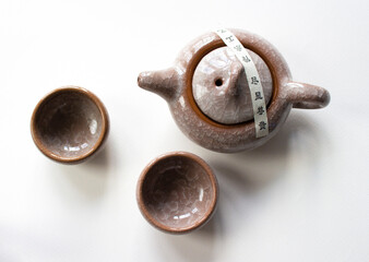 Chinese tea set. brown teapot and 2 teacup with isolated on beautiful white background