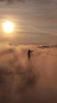 Aerial view of the sunrise of the statue of Jesus Christ located on the peak of Buntu Burake Hill in Makale, Tana Toraja, South Sulawesi, Indonesia