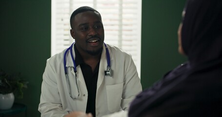 Doctor concludes consultation, stands up to leave the patient room.