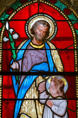 Fototapeta premium Stained glass (19th century) of Saint Joseph with Jesus Christ.