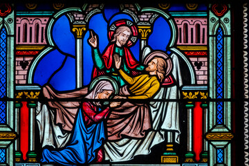 Fototapeta premium Stained glass (19th century) of Death of Saint Joseph surrounded by Mary and Jesus.