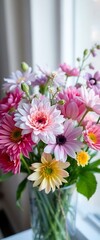 Fototapeta premium vase filled with lots of pink and yellow flowers