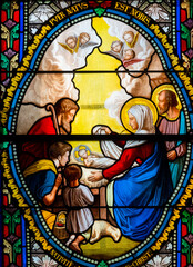Naklejka premium Stained glass (19th century) of Christmas Nativity Scene with Virgin Mary, Saint Joseph, and Jesus baby.