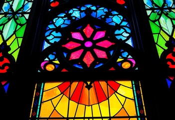 colorful stained glass window with a cross on it