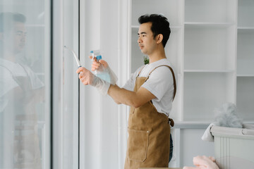Man Cleaning Window with Squeegee