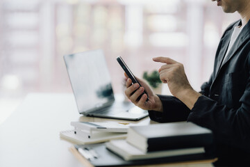 Fototapeta premium Businessman Using Mobile Phone at Desk