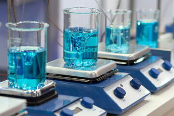 Mixer stirring liquid in beaker in the medical laboratory