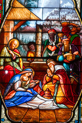 Obraz premium Stained glass (19th century) of Christmas Nativity Scene : Adoration of the Magi as they present gifts of gold, frankincense and myrrh to the Infant Jesus.