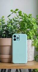 Mint phone case with plants, and wood shelf.