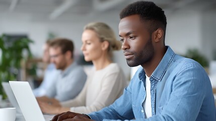 Obraz premium Focused employees working on laptops in modern office. 