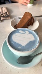 Delicious Dessert Indulgence Blue Matcha Latte Art and Chocolate cheesecake Delight on Tabletop