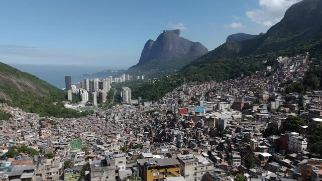 Aerial view of Rio de Janeiro, Brazil, flying over Favela da Rocinha toward Pedra da Gavea mountain on a sunny day. Rocinha is the largest favela in Brazil and the second largest in Latin America. 