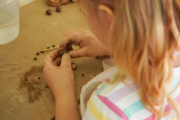 A child sculpts a souvenir from clay. Summer master classes, recreation