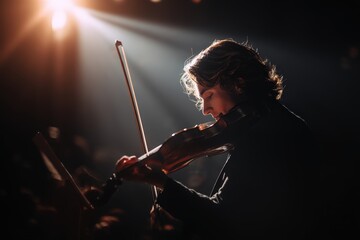 Fototapeta premium Male musician passionately playing violin on stage.