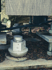 Reinforced concrete foundation with metal anchor bolts