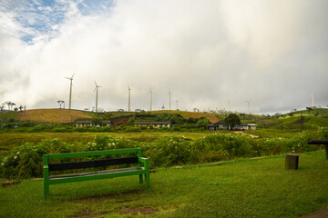 A Bench, Wind Power Generation Fans (Windmills) and Grasslands of Ambewela Farm, Sri Lanka.