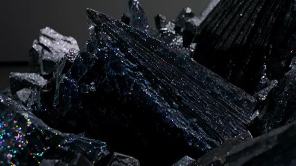 Close-up shot captures jagged crystalline structures, showcasing dark metallic hues and iridescent glitter, creating an otherworldly mineral composition. - Powered by Adobe