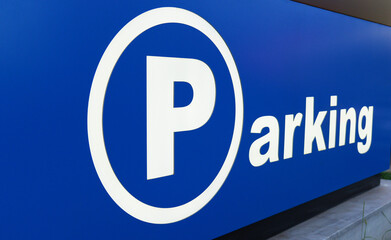 Large blue parking sign indicates available space for vehicles nearby