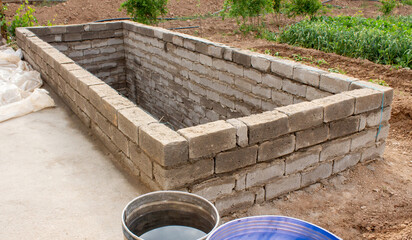 Naklejka premium The process of building a home pool for storing water