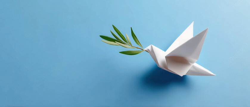 Origami dove carrying an olive twig symbolizes a call for world peace and an end to conflict. copy space, concept of peace and truce, no war